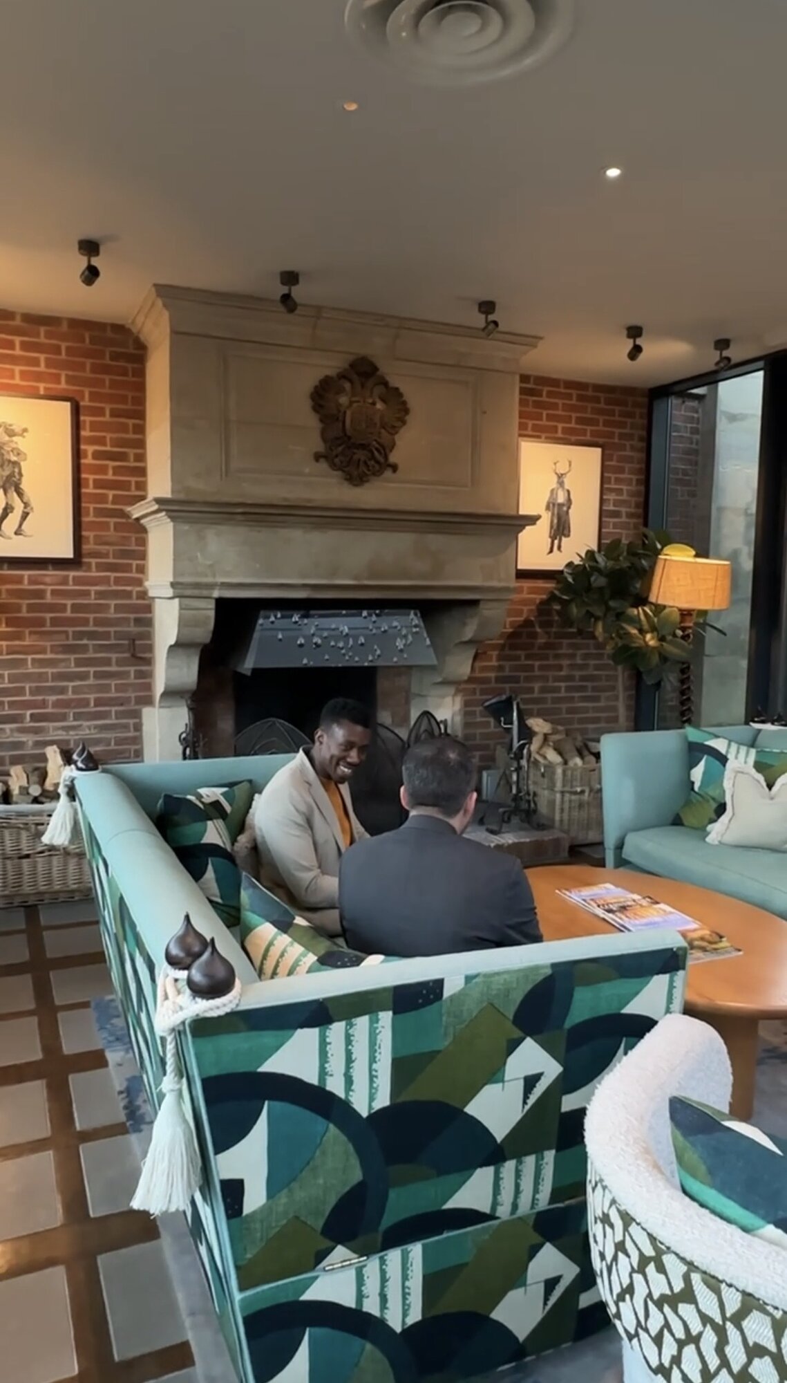 John and a client in a hospitality lounge, mid-conversation